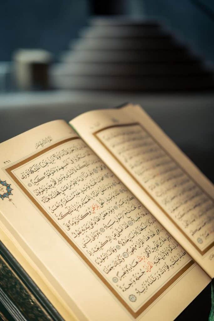 pexels photo 20784662 Close-up of an open Quran with Arabic script in a peaceful indoor setting.