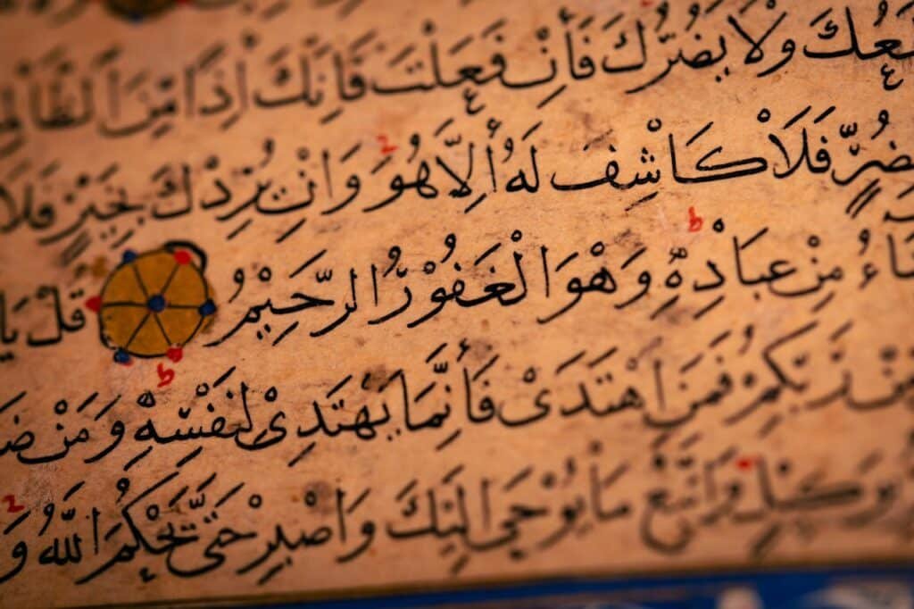 Detailed close-up of Arabic calligraphy on an ancient manuscript, showcasing historical text.